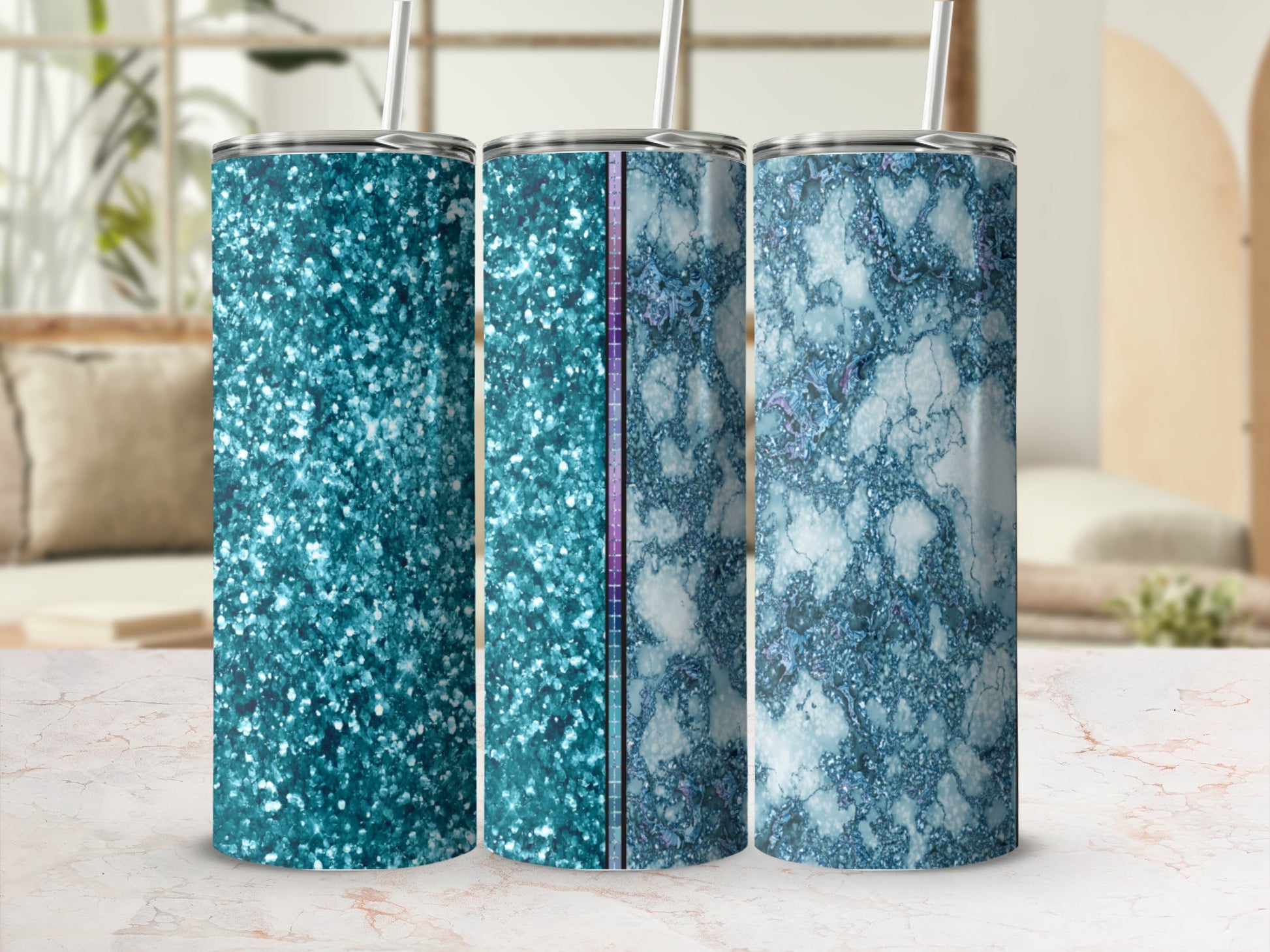 Three glitter and marble pattern tumblers with straws, displayed on a table.