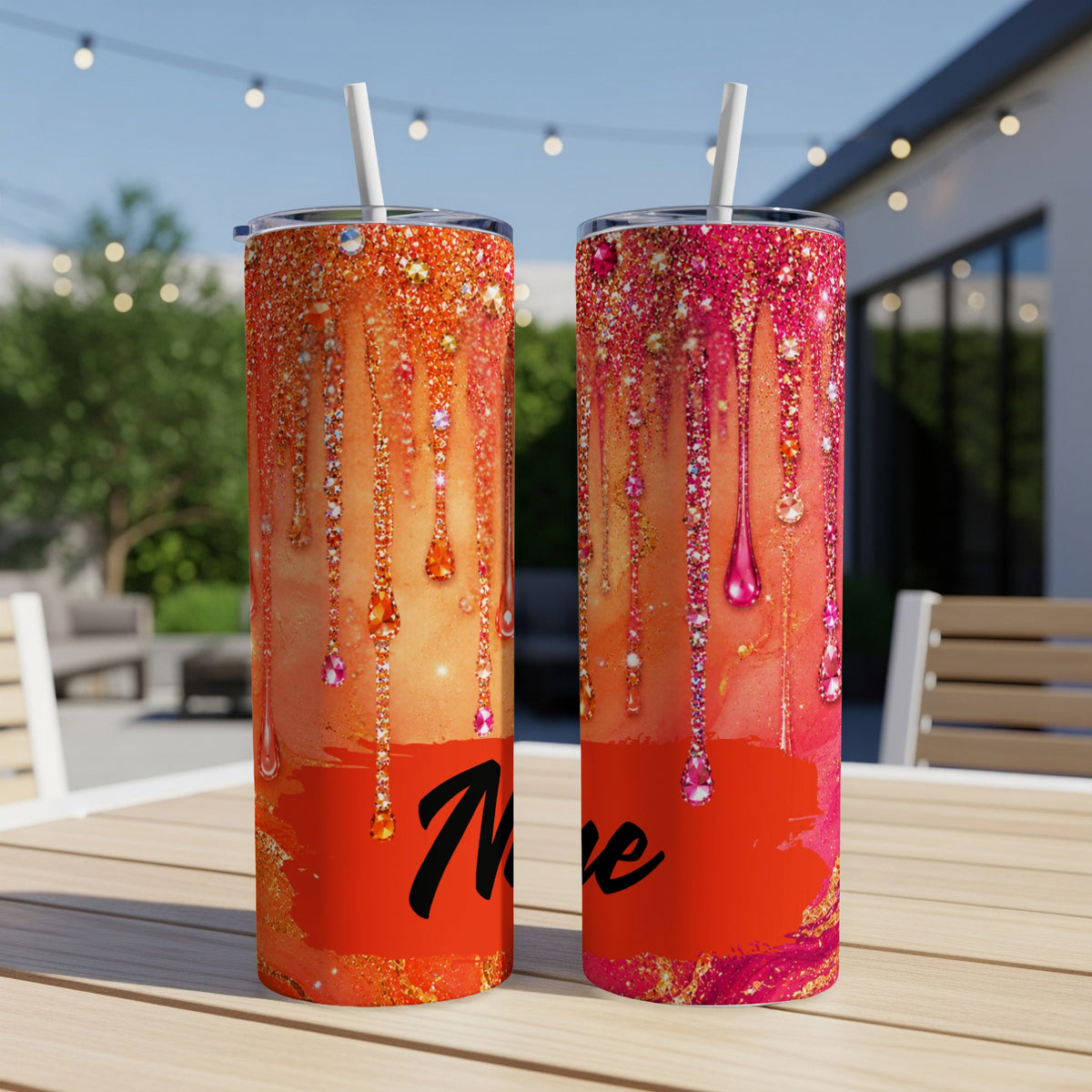 Two tumblers with glitter and dripping jewel designs, one orange, one pink.