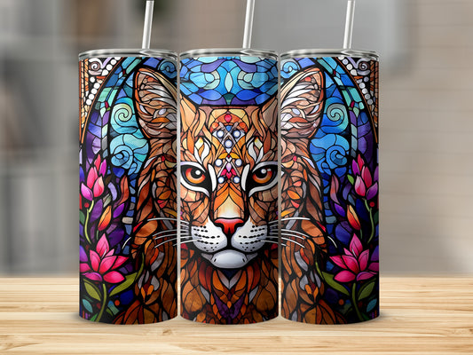 Stained glass bobcat face with floral accents on a tumbler.