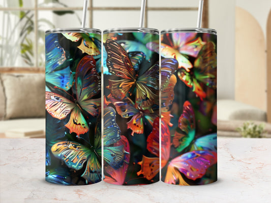 Three tumblers with iridescent butterfly designs and straws.