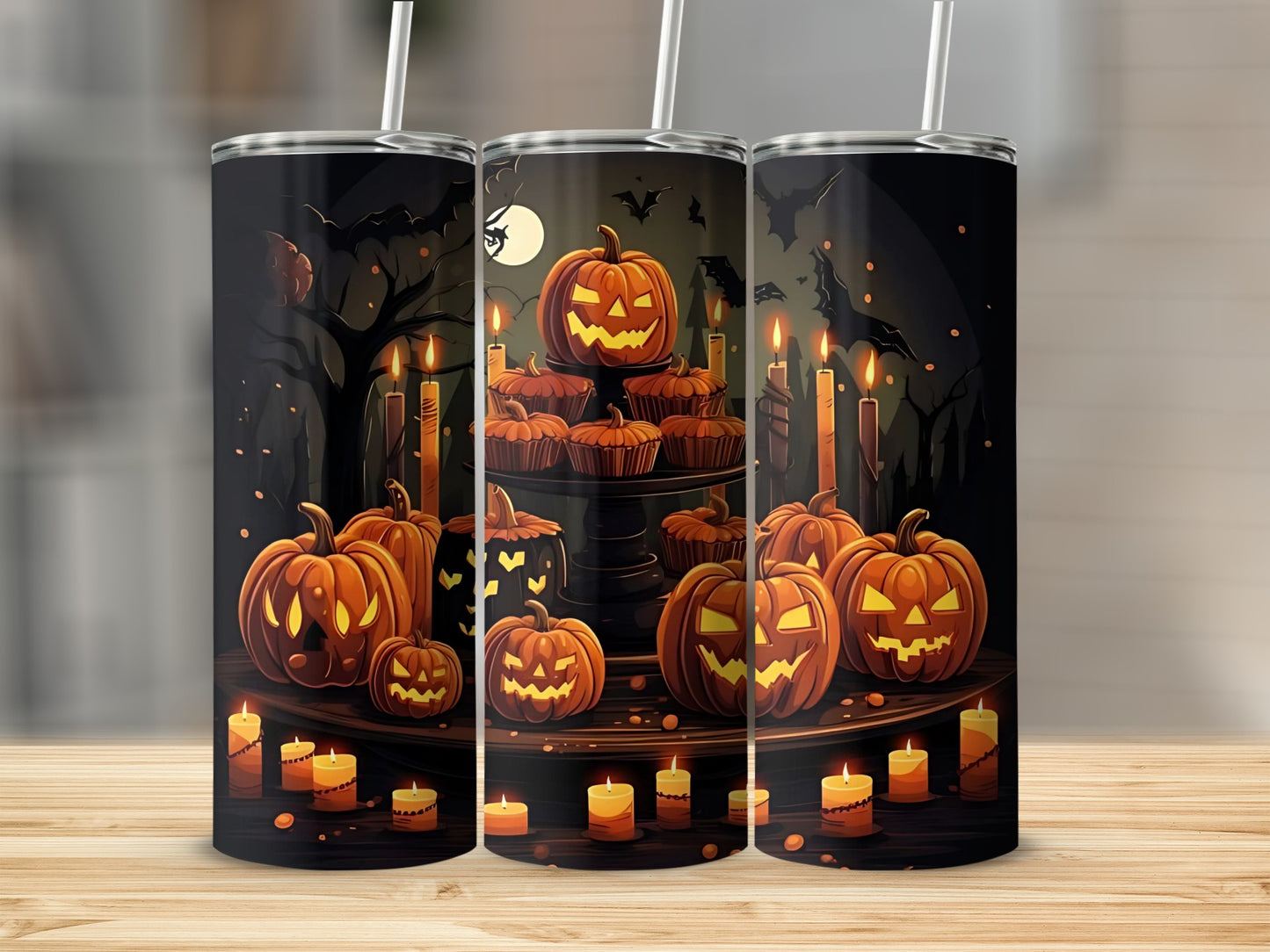 Tumbler with Halloween design of pumpkins, cupcakes, candles, and bats on a dark background.