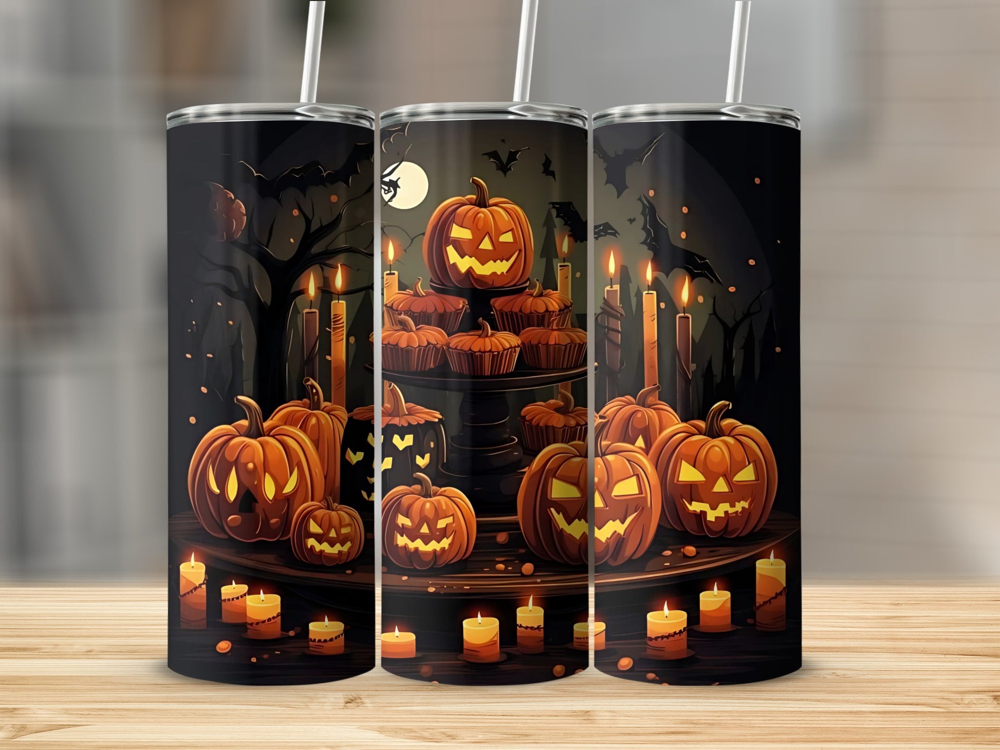 Tumbler with Halloween design of pumpkins, cupcakes, candles, and bats on a dark background.