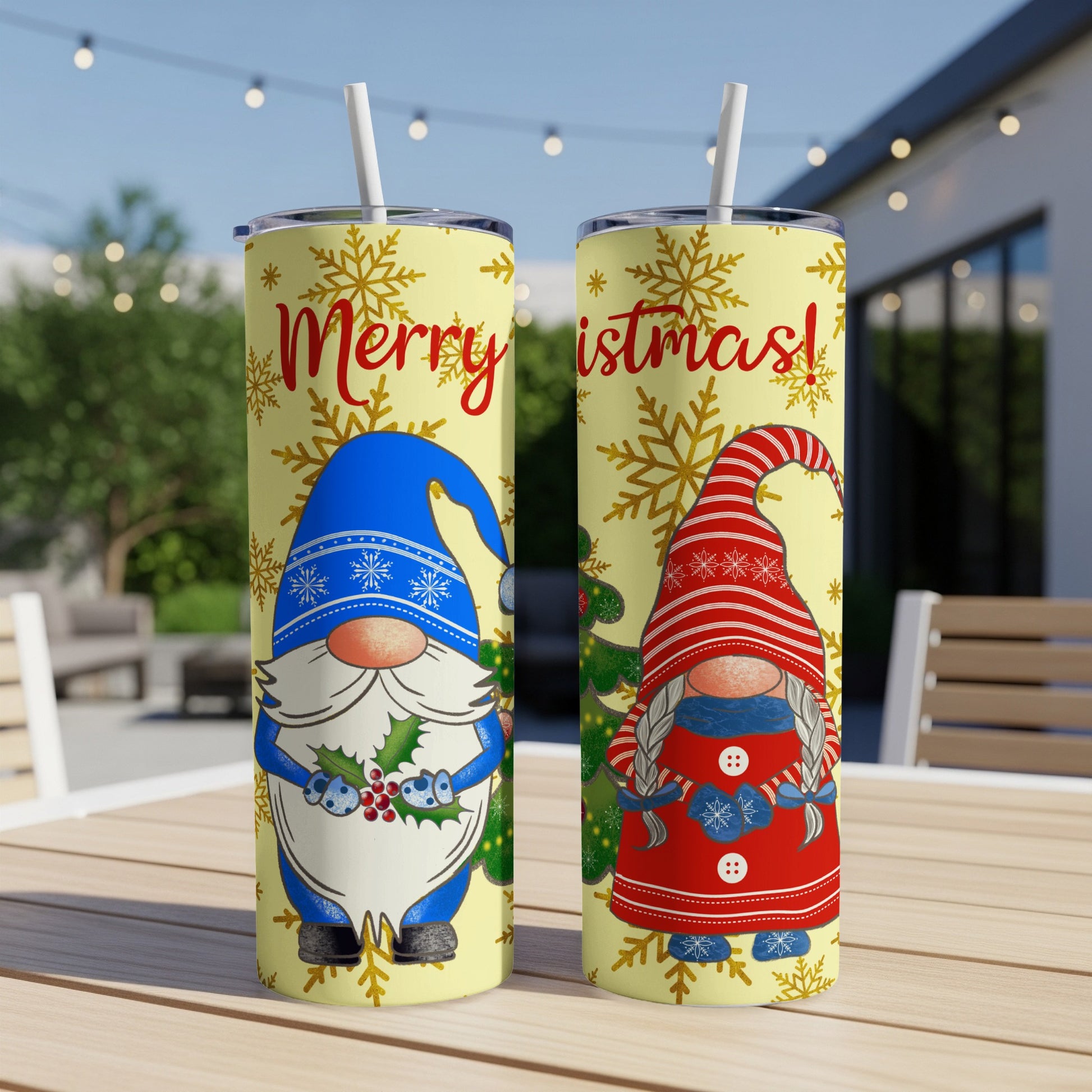 Two tumblers with "Merry Christmas!" text and gnome designs, outdoors.