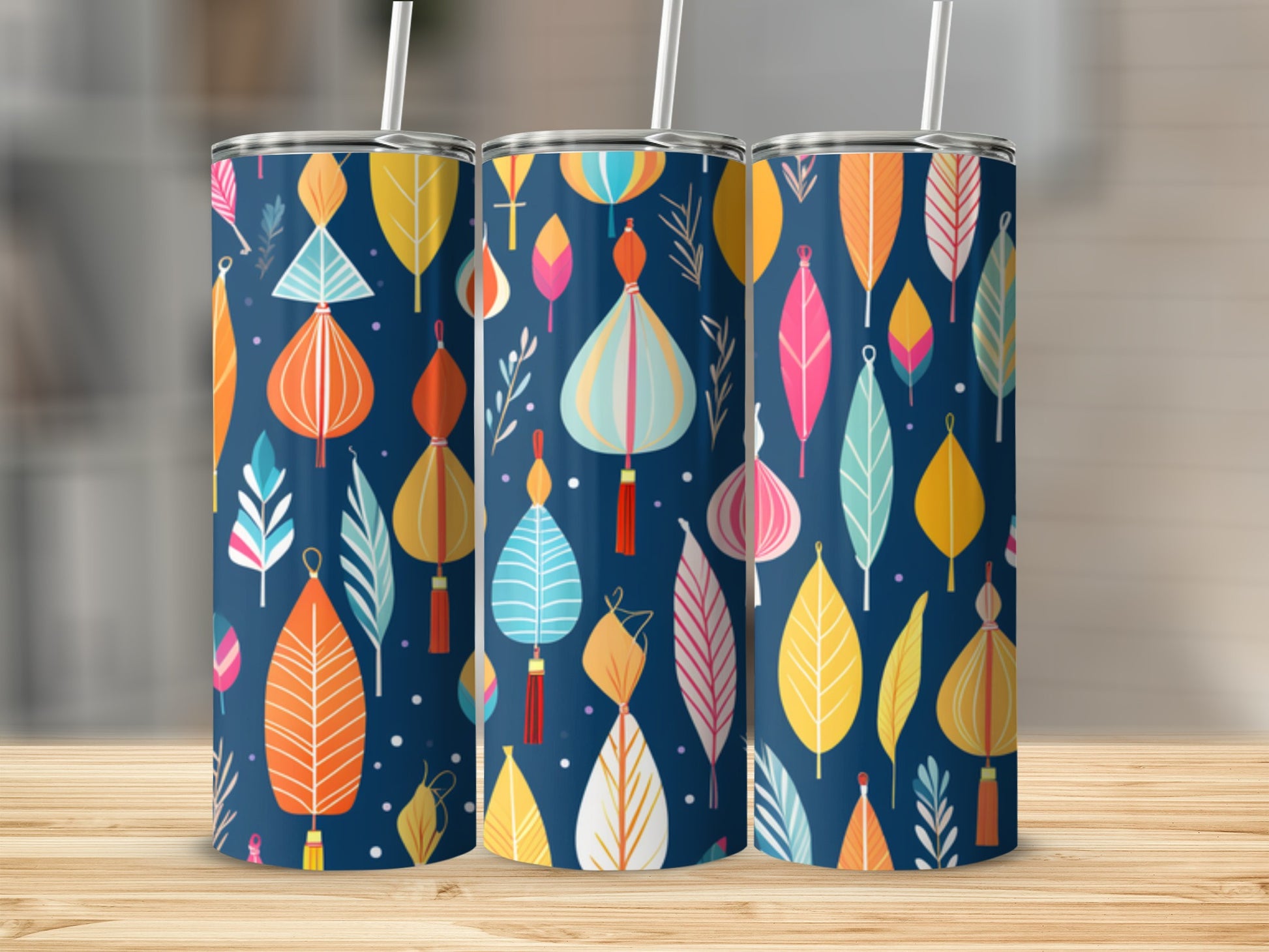 Three tumblers with a pattern of colorful lanterns and leaves on a dark blue background.