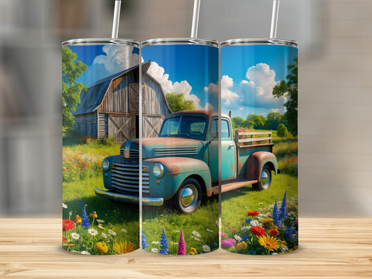Rustic turquoise pickup truck in a field of wildflowers, with a barn and trees.