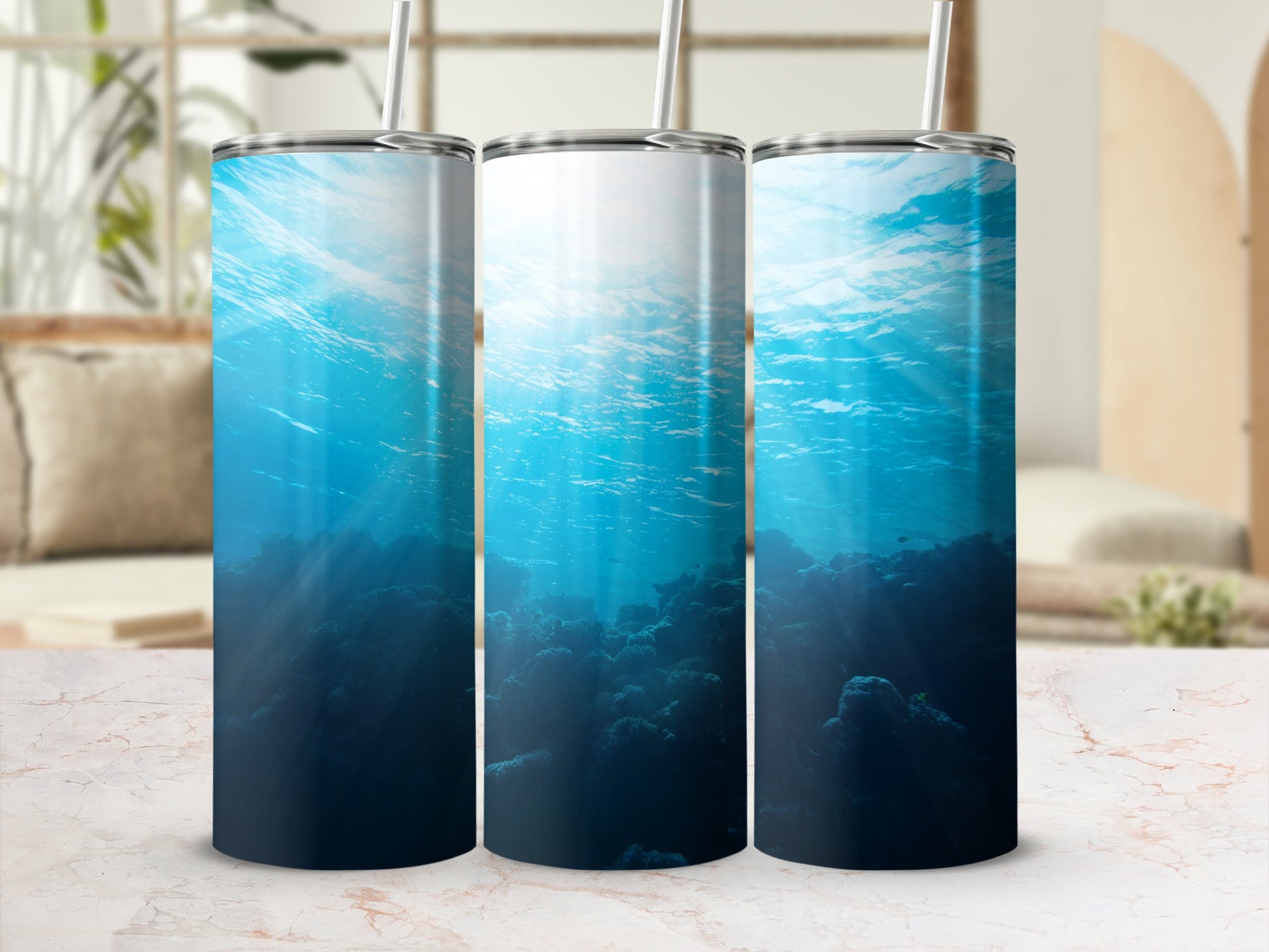 Underwater scene with sunbeams on coral, on three tumblers.