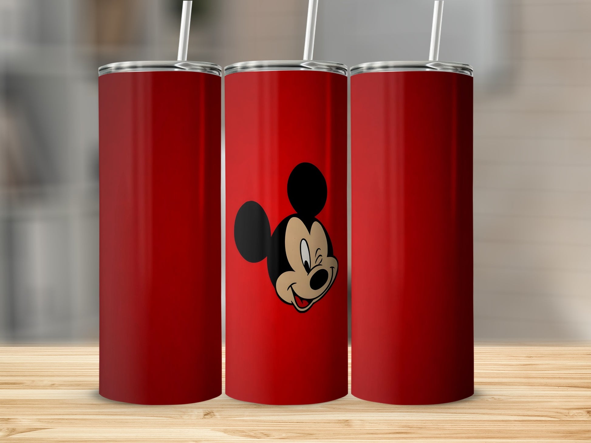 Three red tumblers, one with Mickey Mouse smiling.