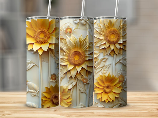 Three tumblers decorated with embossed sunflowers and leaves on a wooden surface.