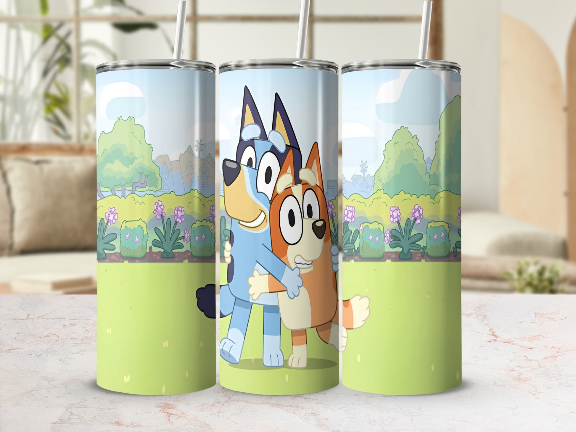 Bluey and Bingo hugging on a tumbler with a cartoon landscape background.