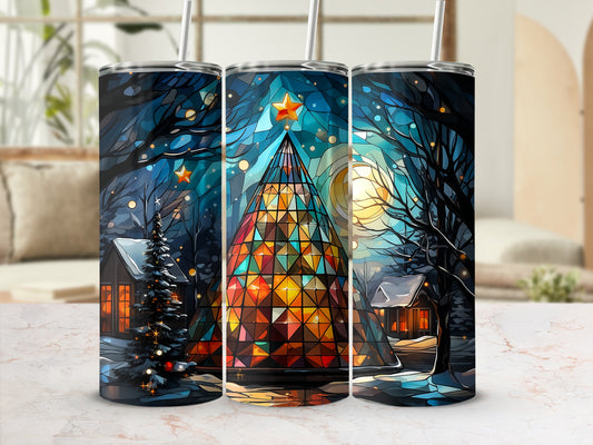 Three tumblers with stained glass Christmas tree in snowy village scene.