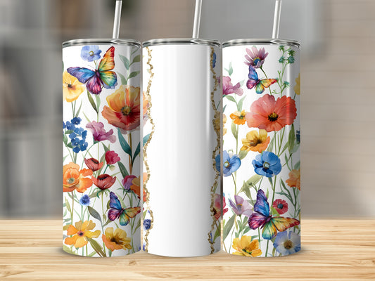 Three tumblers with colorful floral and butterfly designs, one blank.