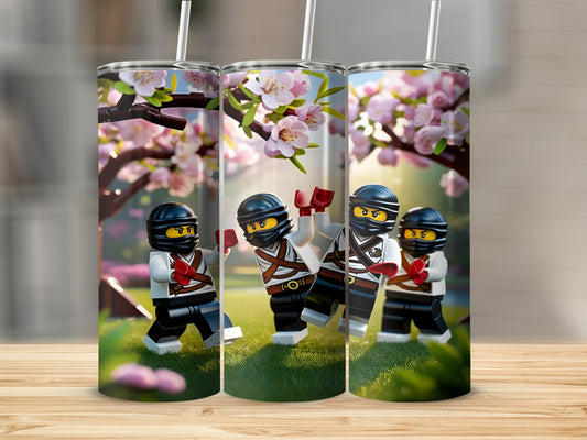Three Lego ninjas with cherry blossoms and grass design on tumblers.
