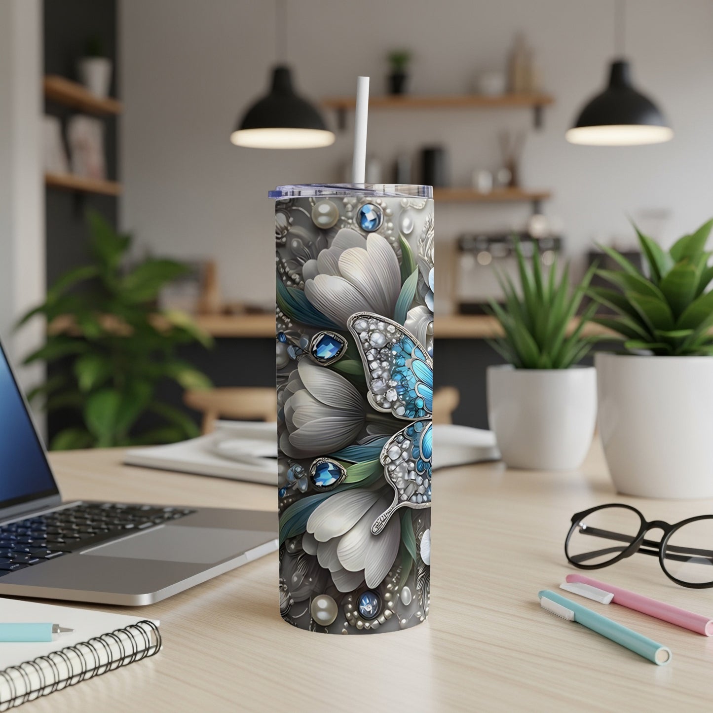 Tumbler with a butterfly and floral design.