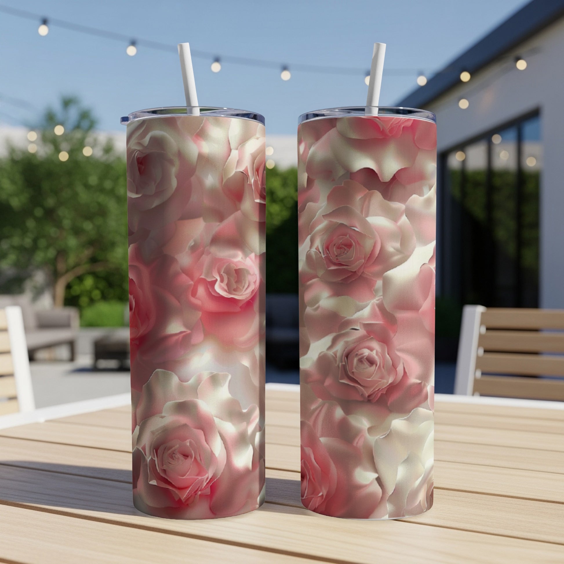 Two pink and white rose pattern tumblers on a wooden table.