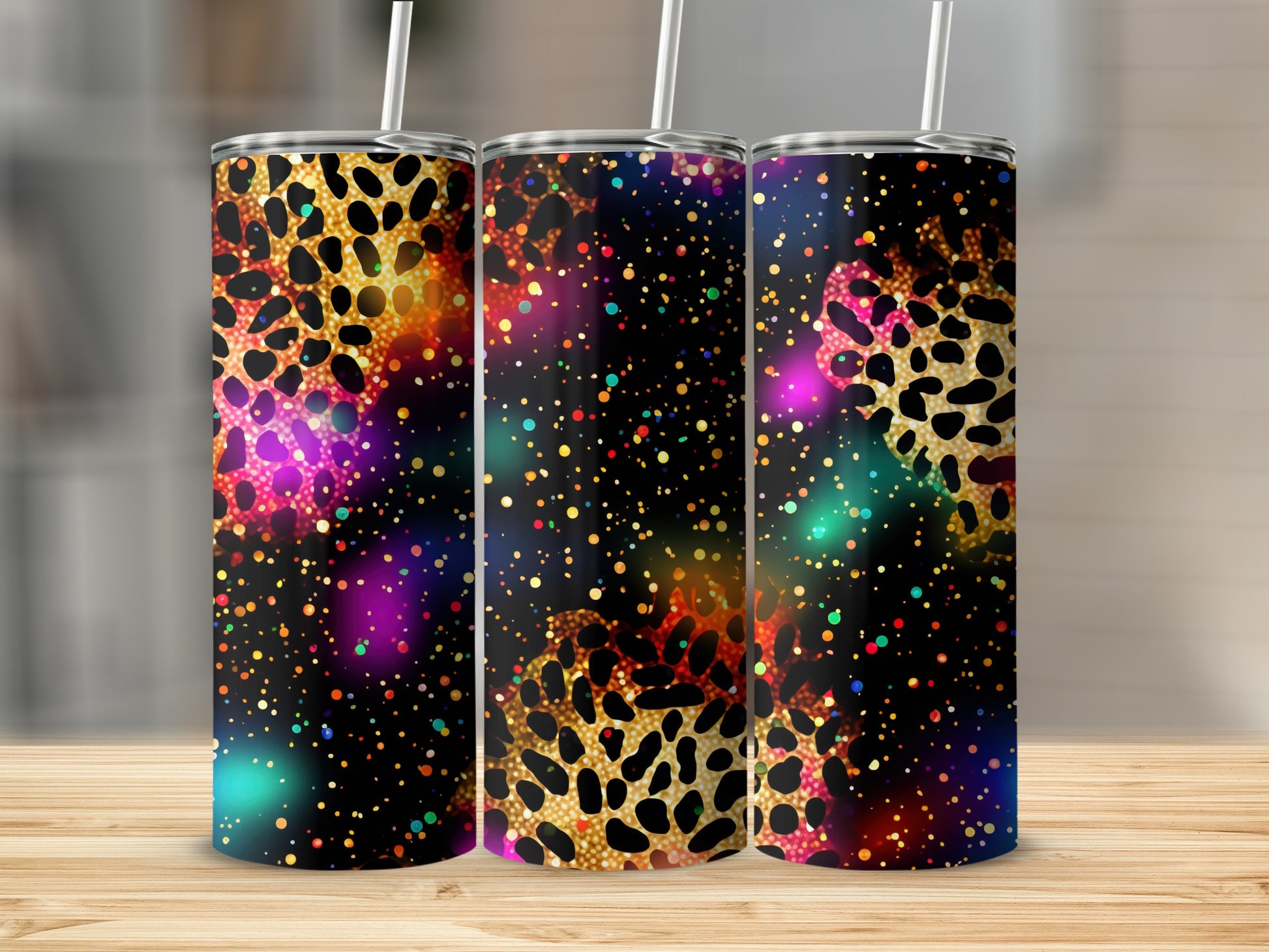 Three tumblers with colorful galaxy and leopard print designs.