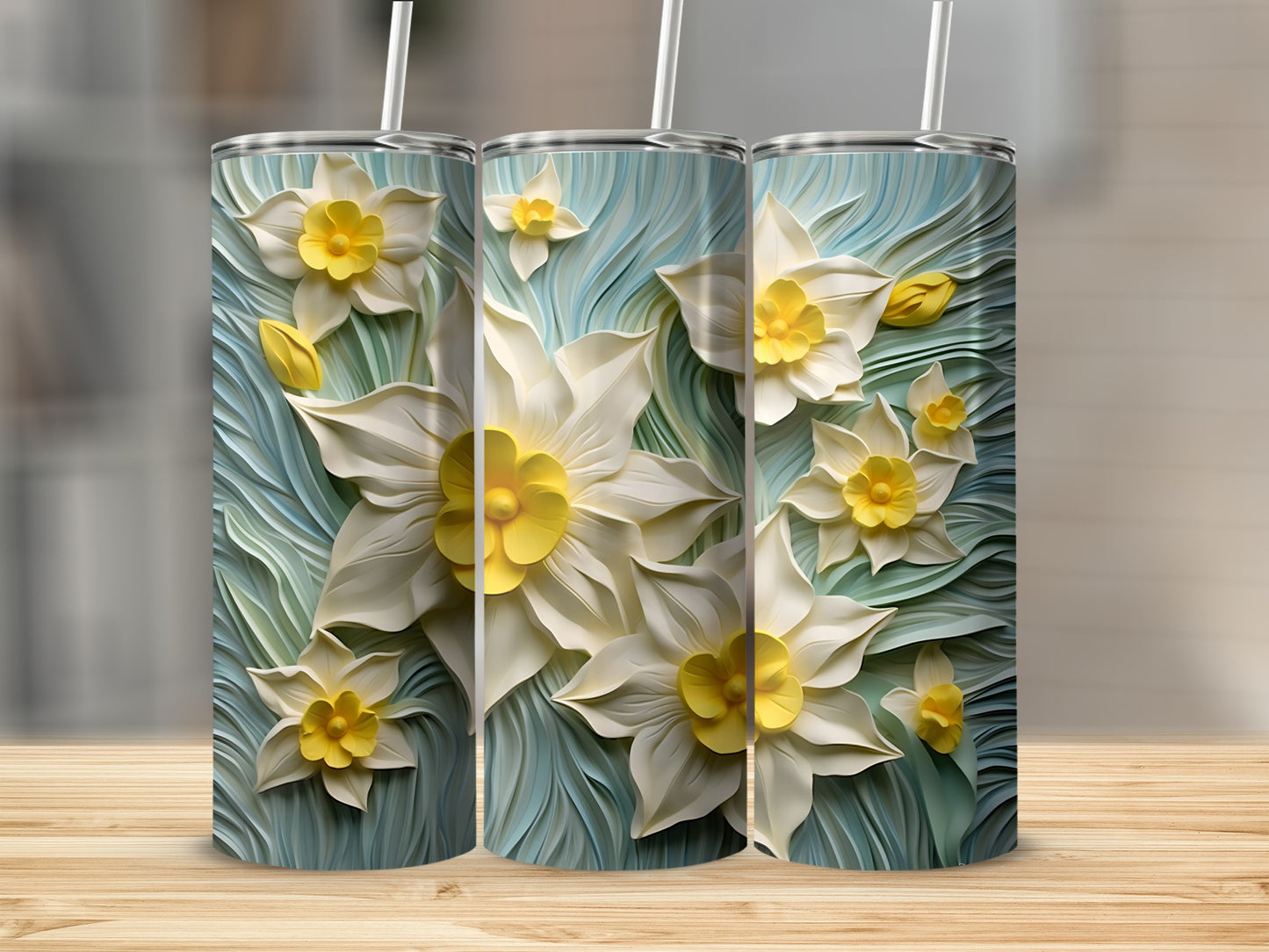 Three tall tumblers featuring a white and yellow daffodil floral pattern.