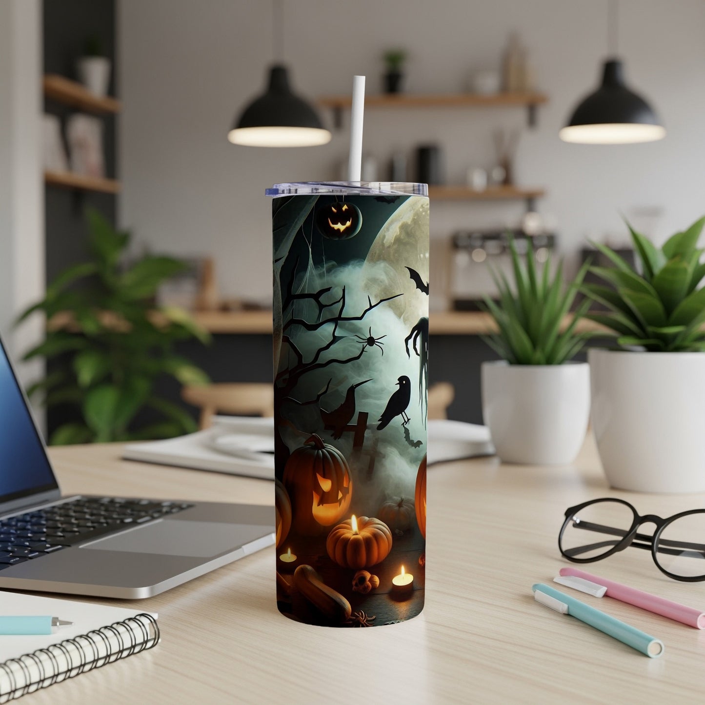 Tumbler with Halloween design featuring pumpkins, bats, ghosts, and a moon.