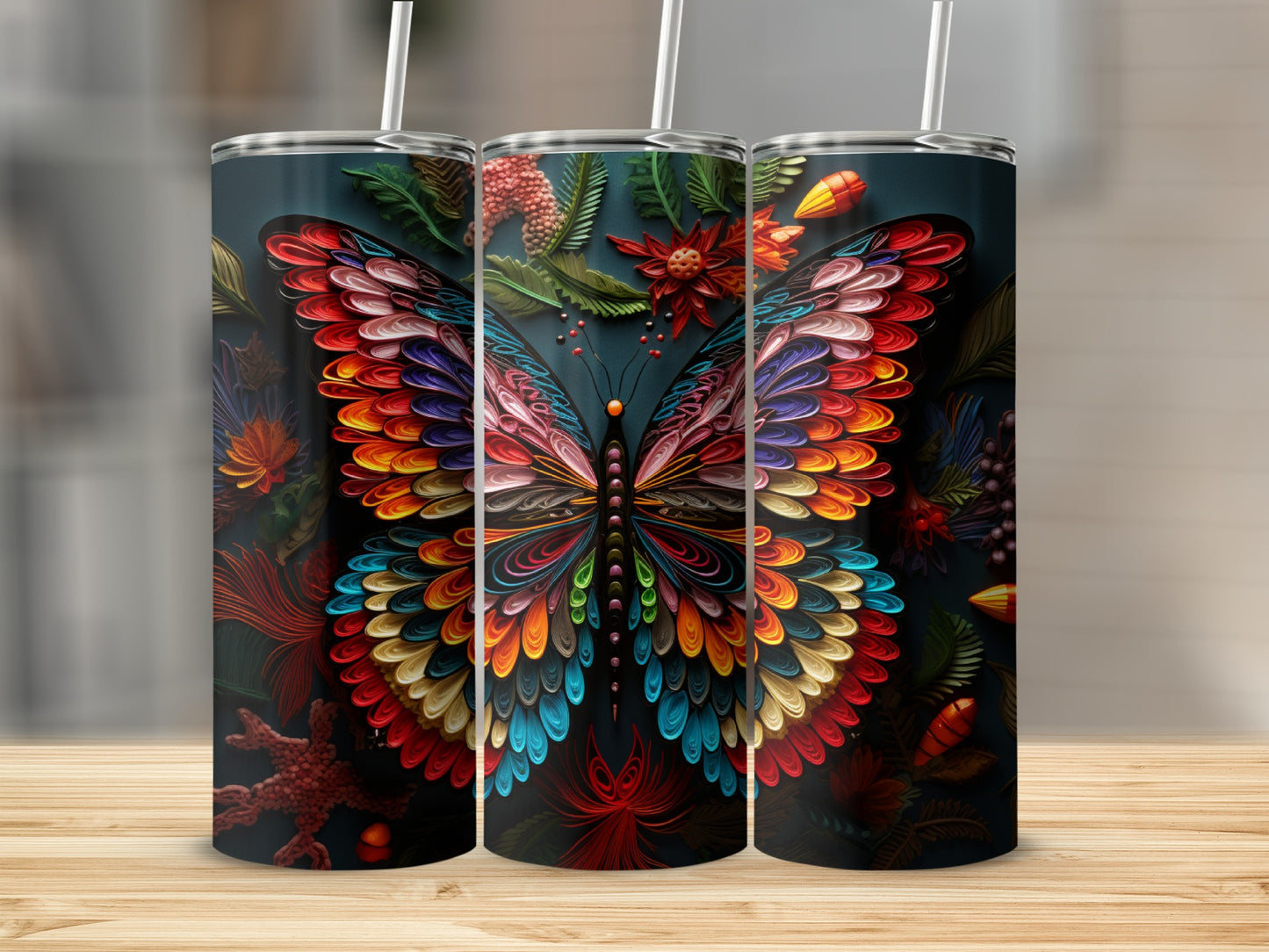 Three tumblers featuring a colorful butterfly design with floral accents.