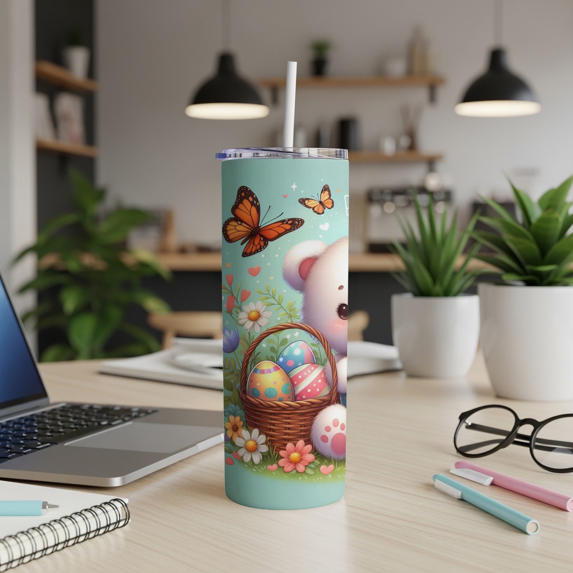 White teddy bear with Easter basket and butterflies on a teal tumbler.