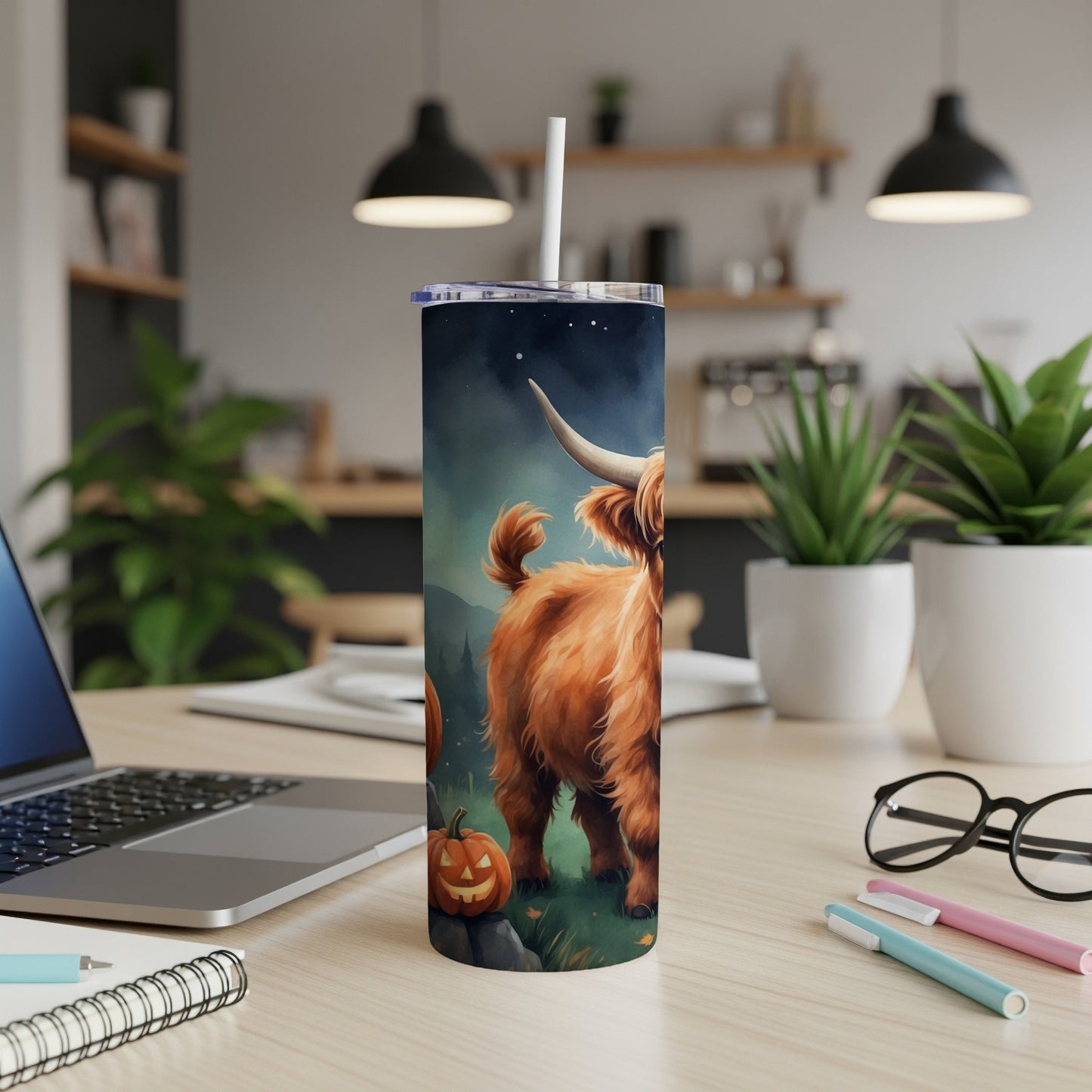 Highland cow with pumpkin and moon on a tumbler with a straw.