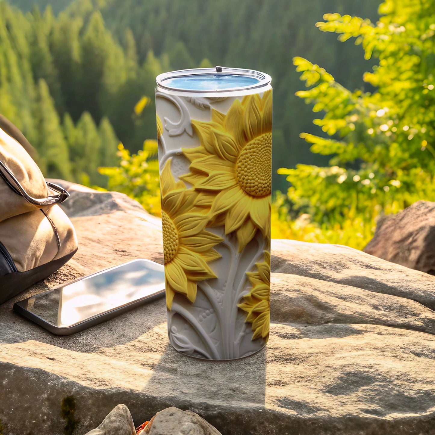 Sunflower tumbler with embossed floral pattern on a rock.