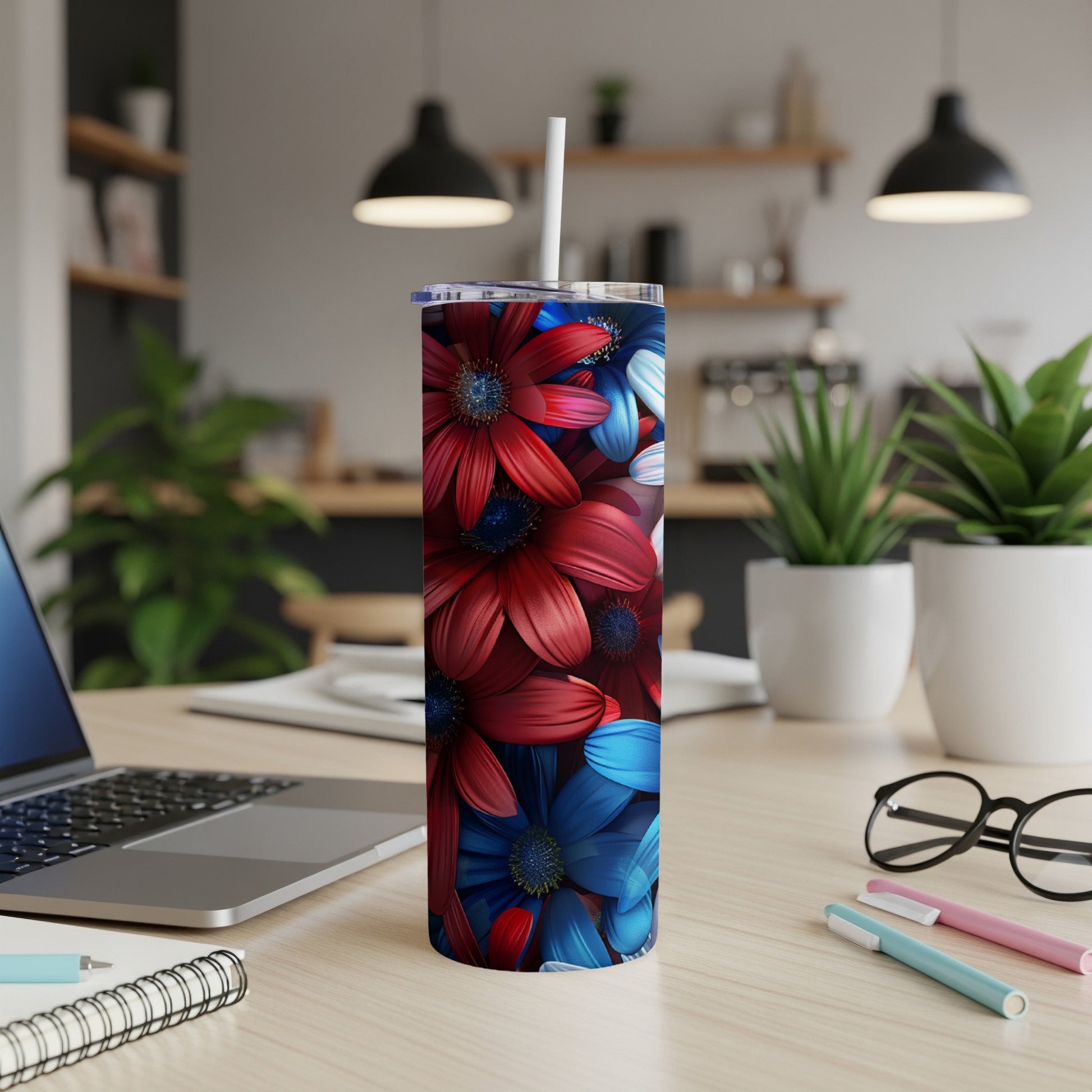 Red and blue floral pattern on a tall tumbler with a straw.