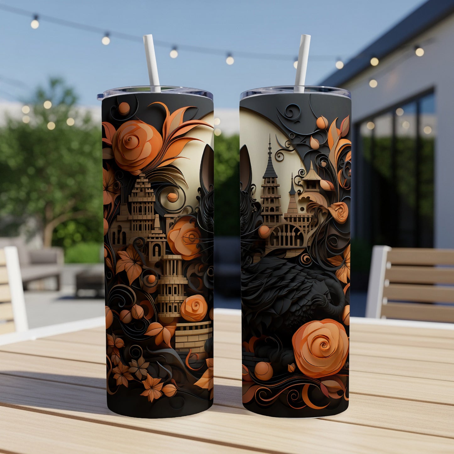 Two black tumblers with orange floral and castle designs.
