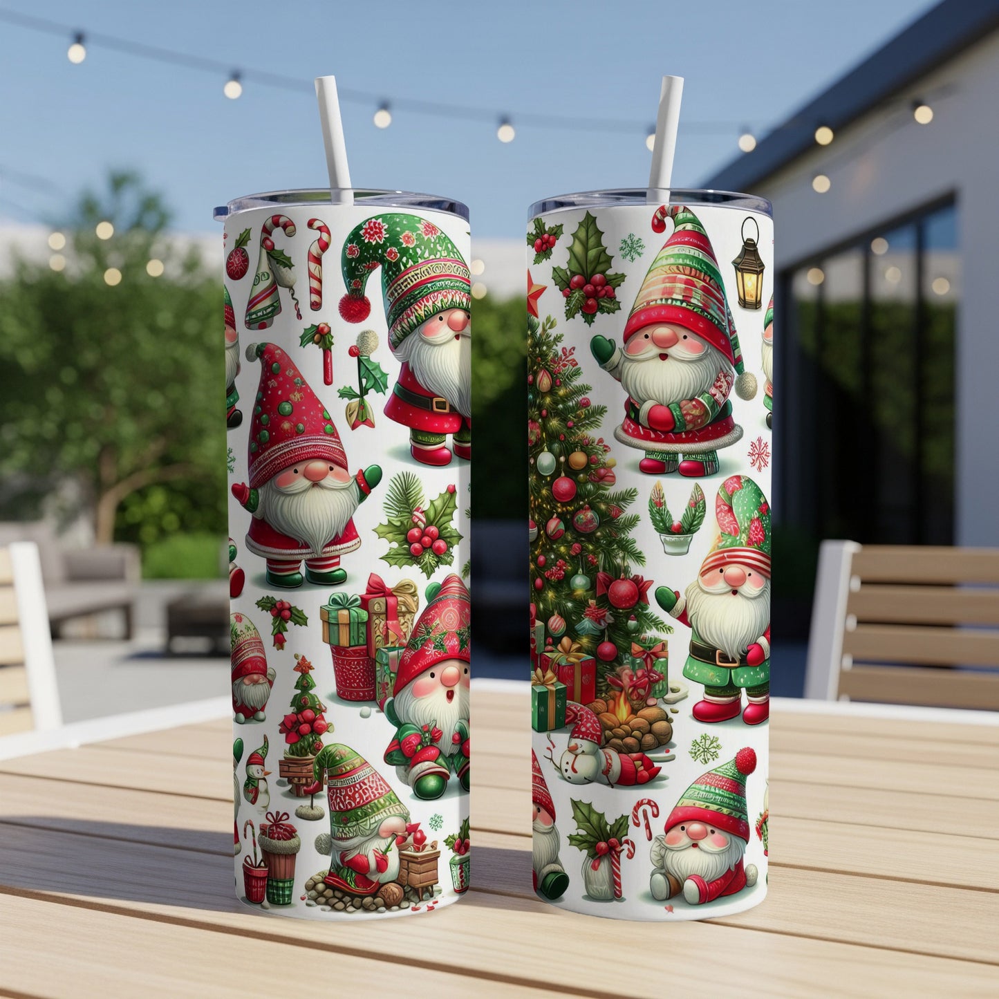 Two tumblers with gnome and Christmas tree designs sit on a table.