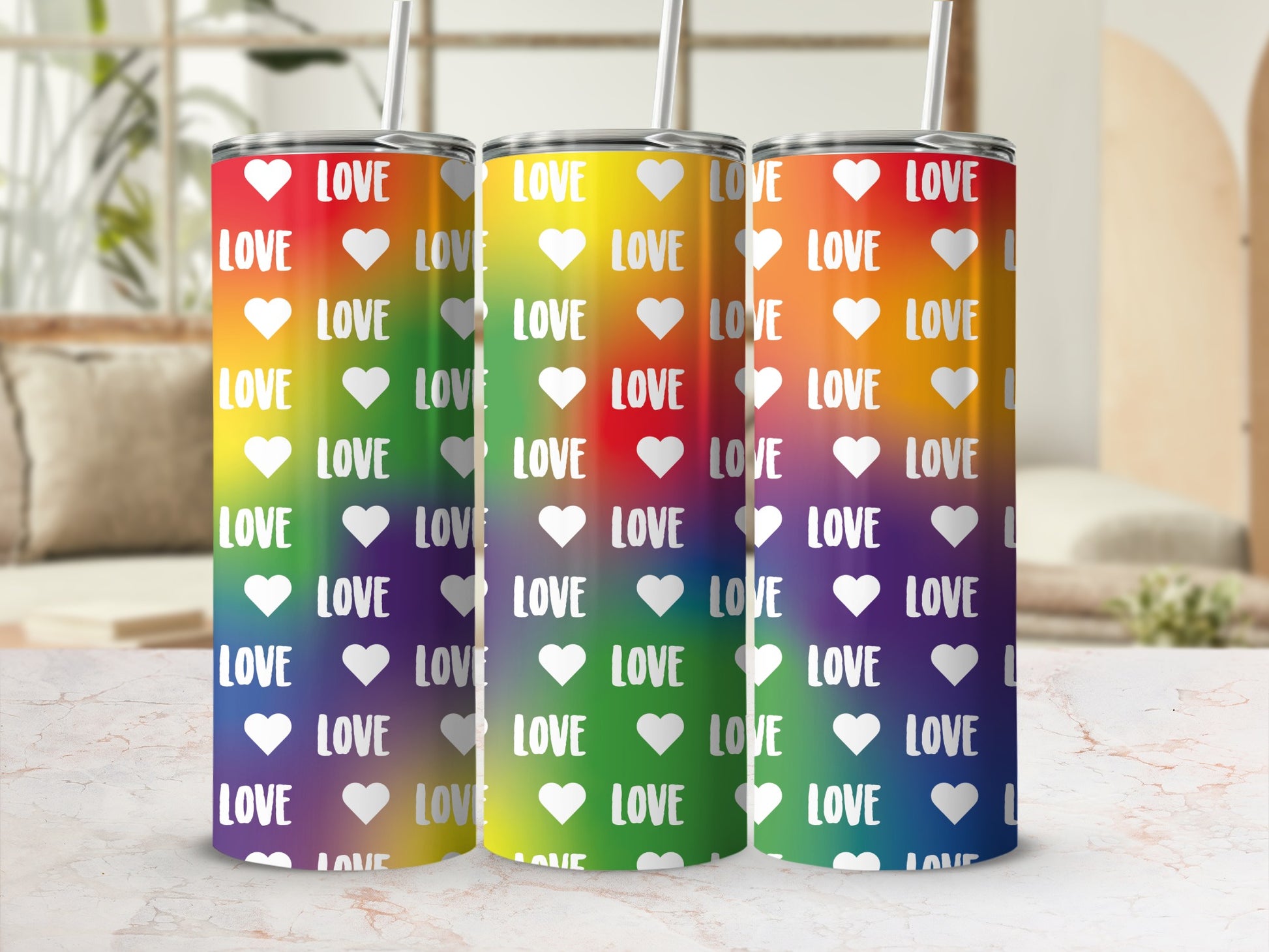 Rainbow tumbler with repeating "LOVE" text and heart icons.