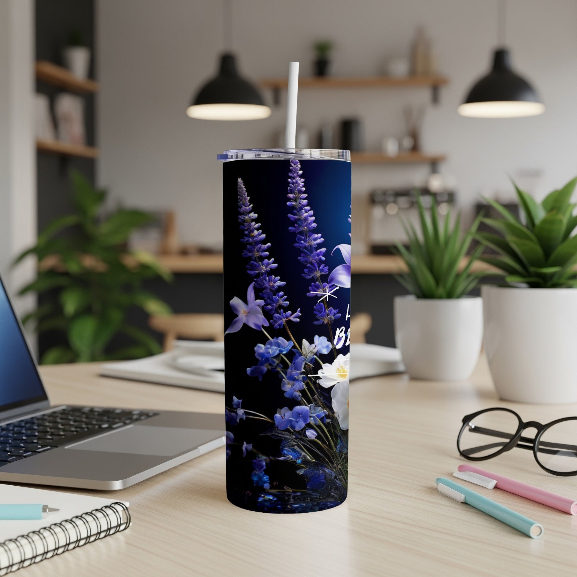 Tall, dark blue tumbler with white flowers and lavender.