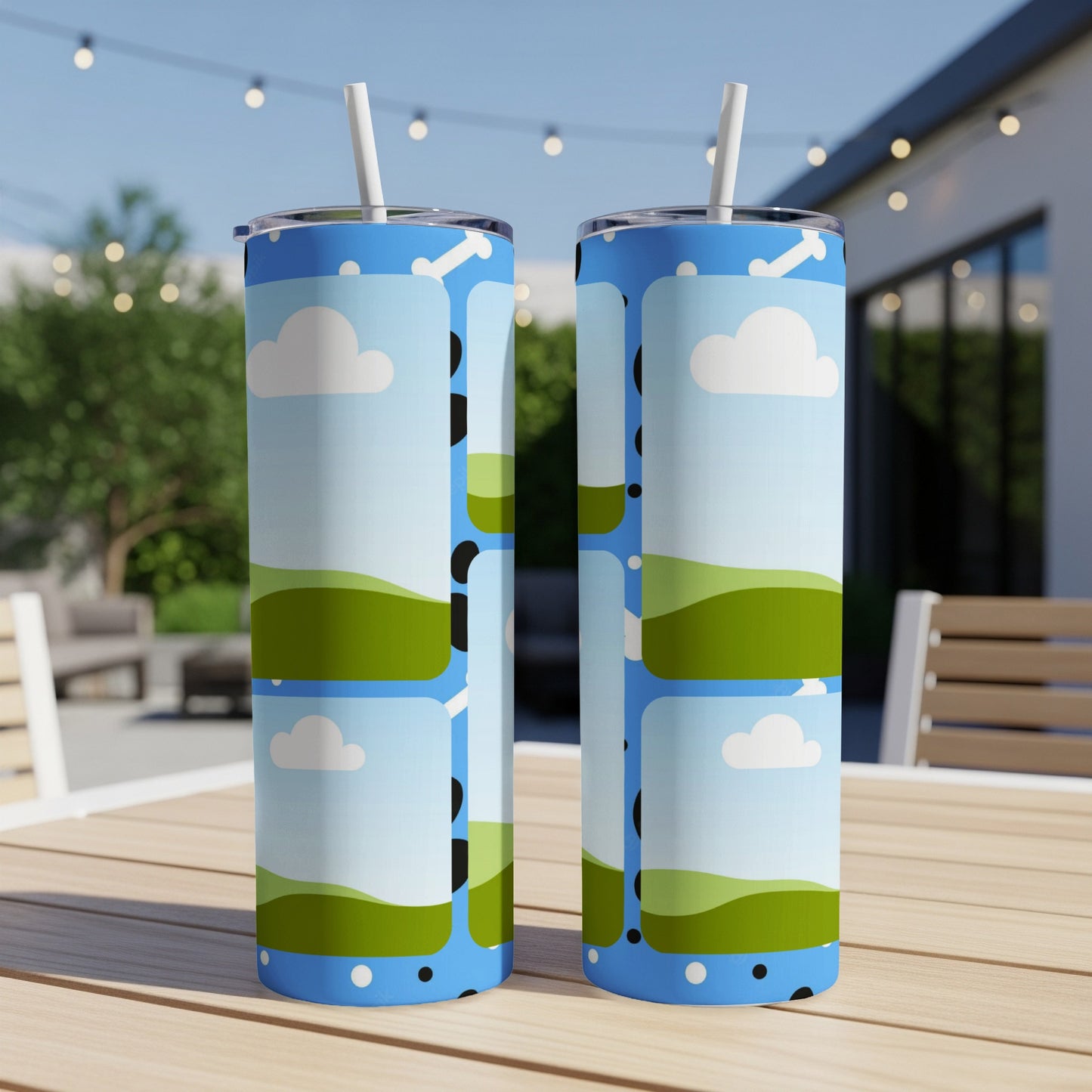 Two skinny tumblers with a blue sky, clouds, and rolling green hills pattern.