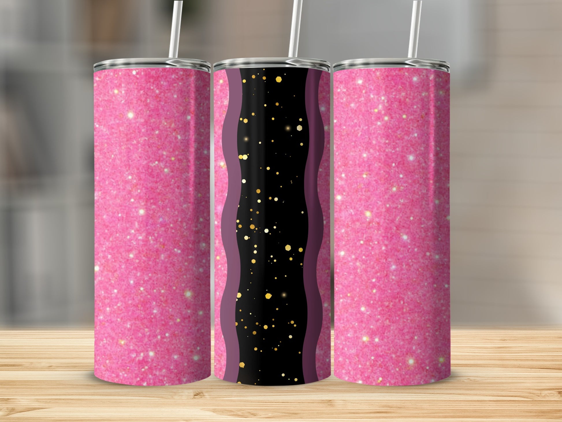 Three glitter tumblers with pink and black designs on a wooden surface.