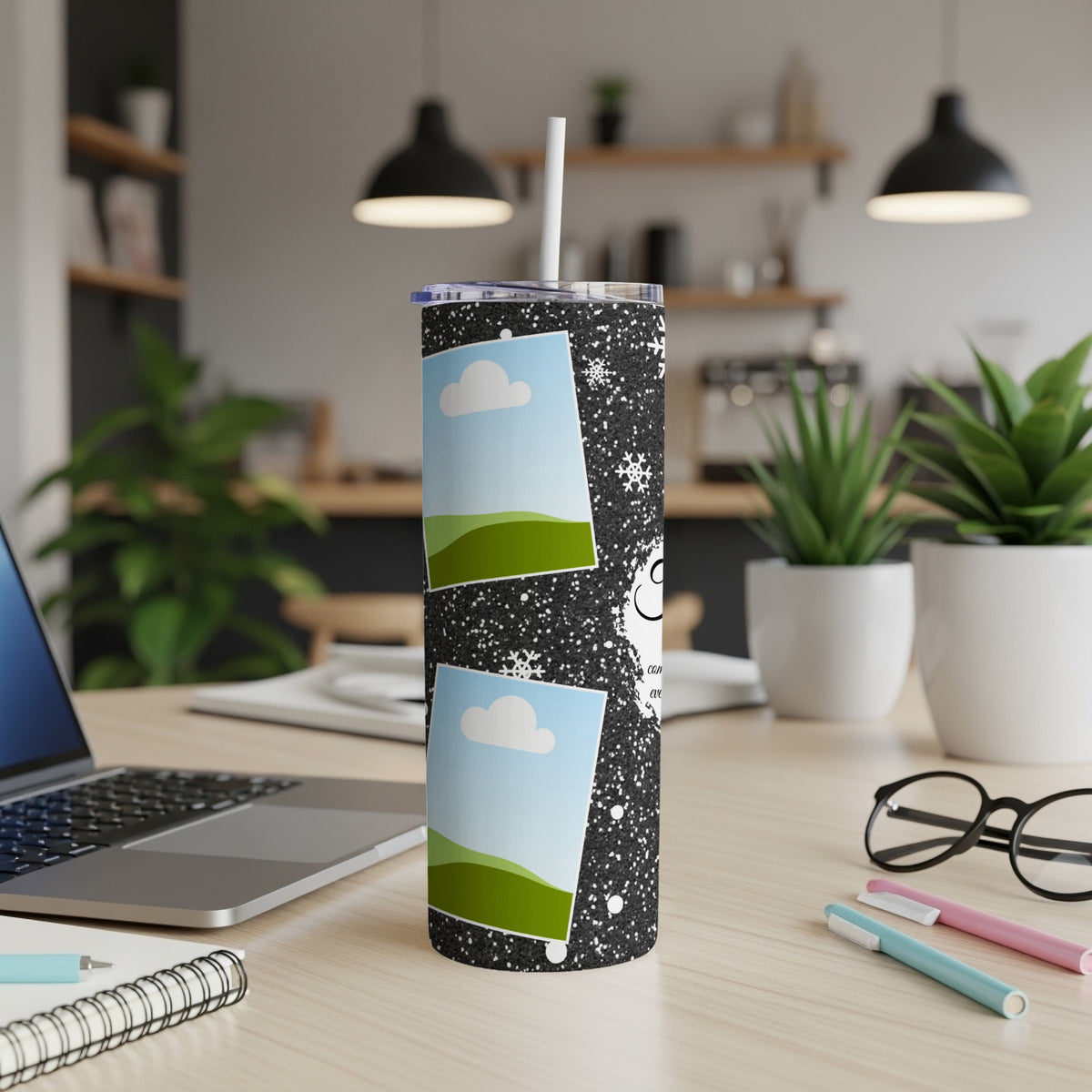 Black glitter tumbler with two photo frames and scattered snowflakes.