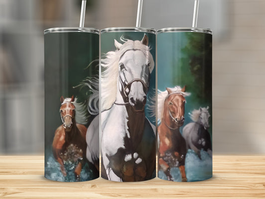 Three horses running through water, white horse in front.