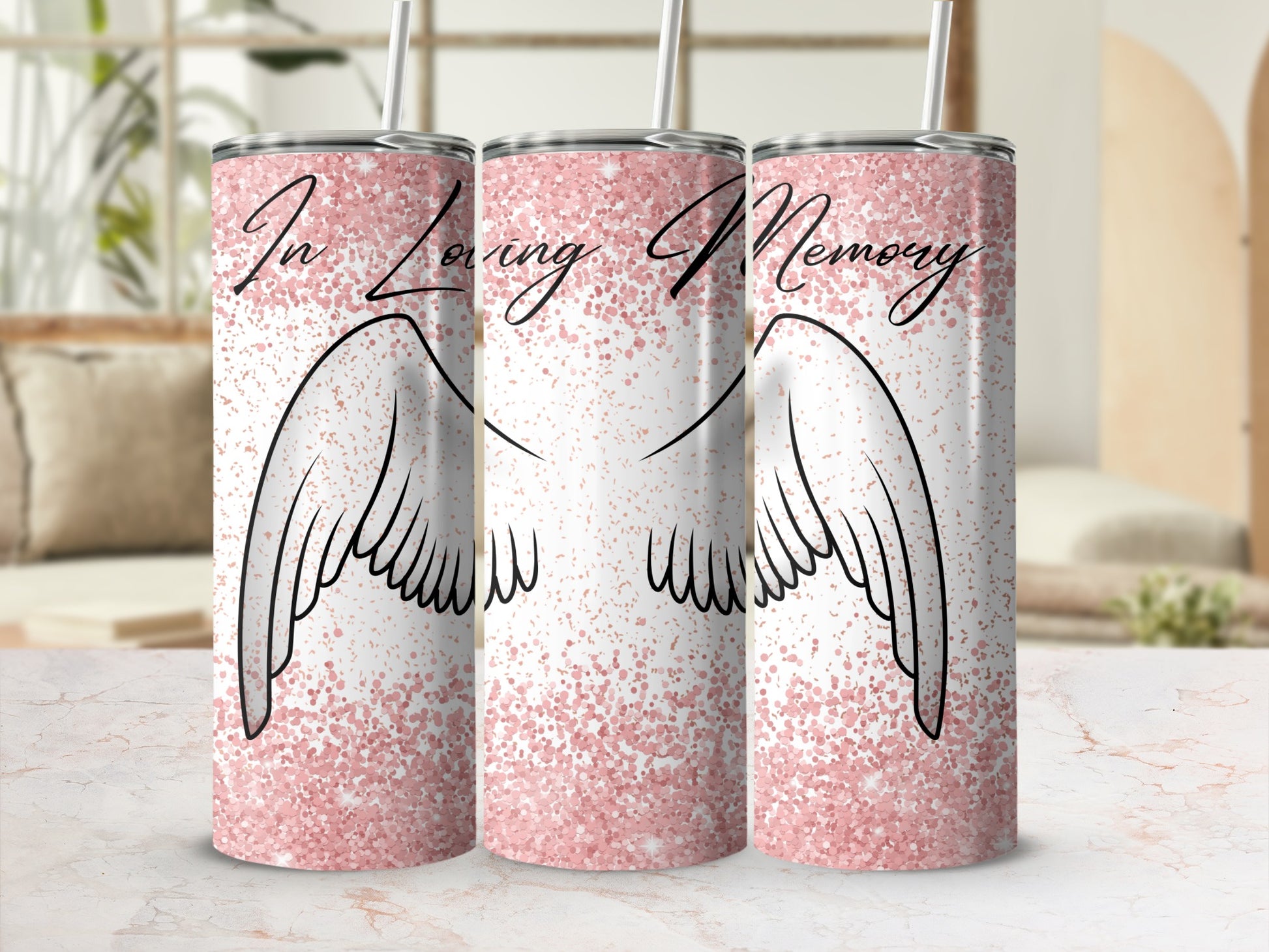 "In Loving Memory" text on a pink glittery tumbler with angel wings.