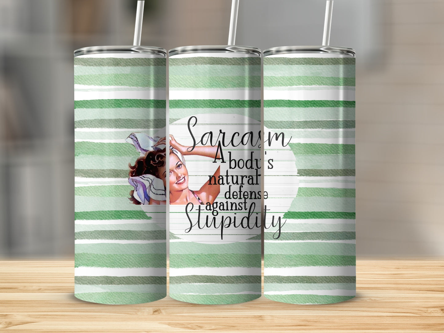 Tumbler with green stripes and quote "Sarcasm A body's natural defense against Stupidity".