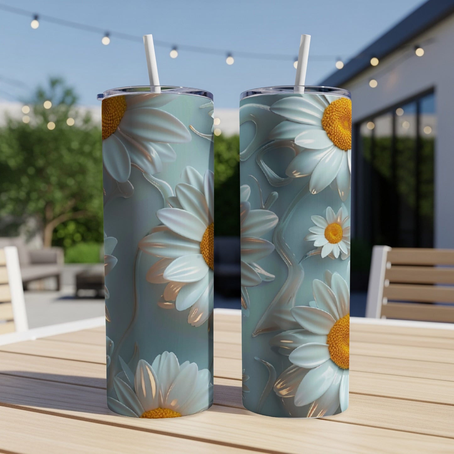 Two tumblers with white daisy floral pattern on a table.
