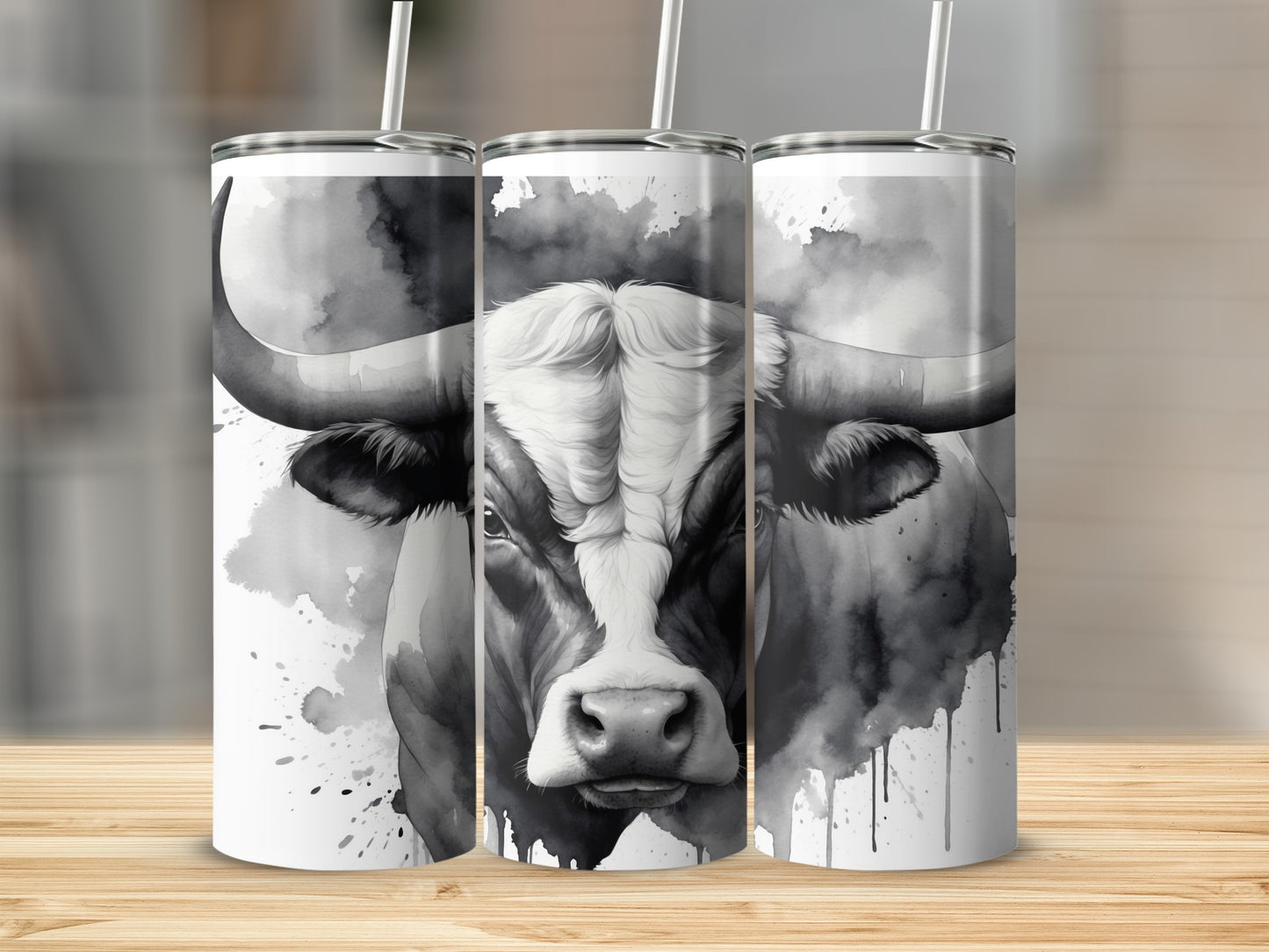 Black and white watercolor bull design on three tumblers.