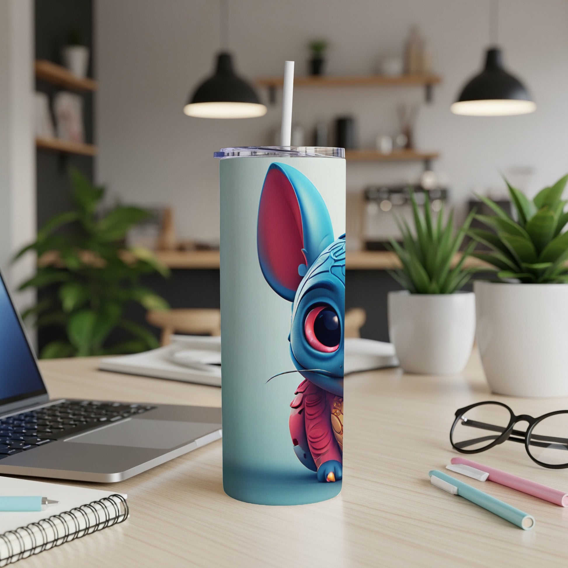 Cute blue creature with large eyes on a white tumbler with straw.