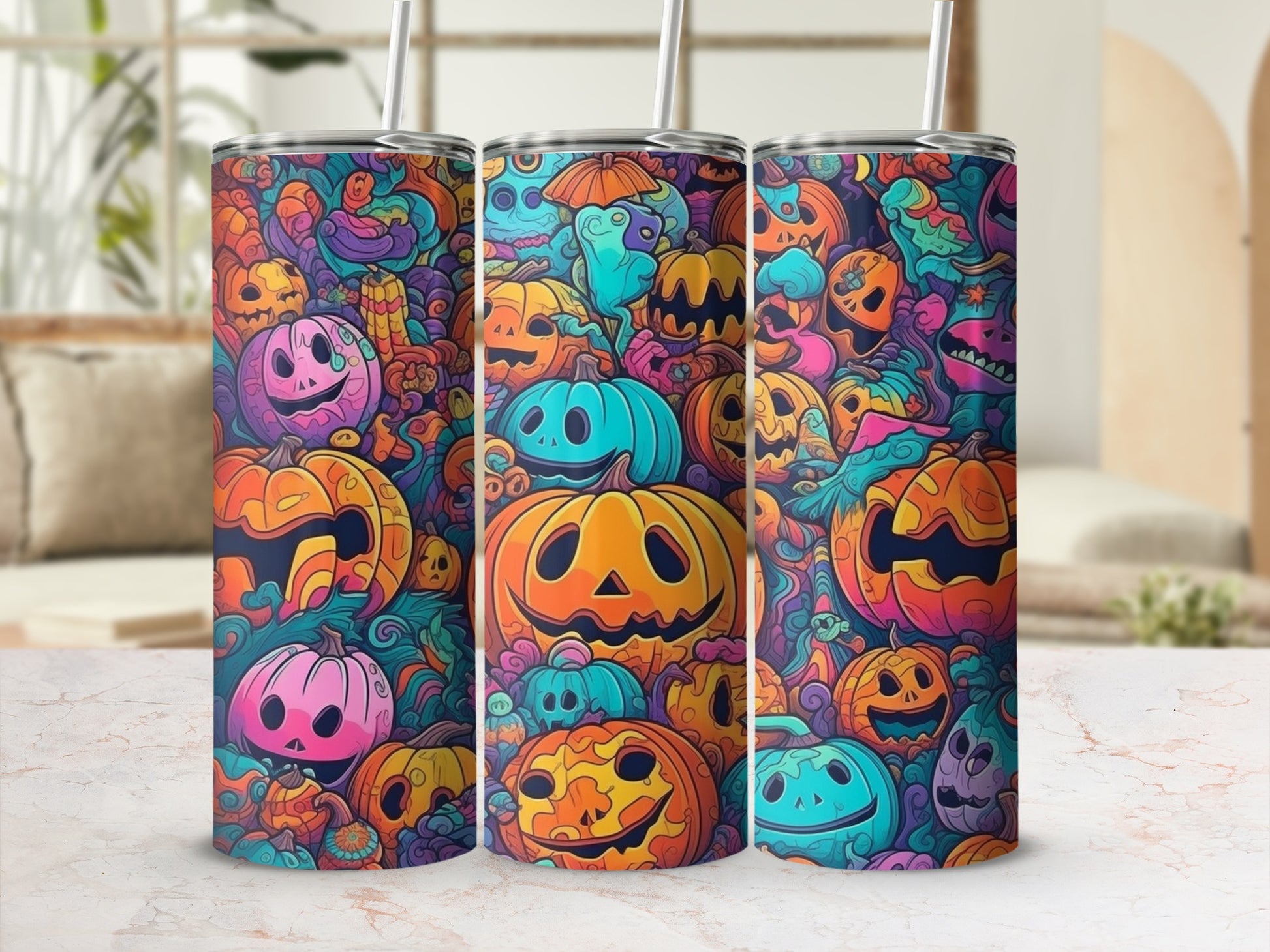 Three tumblers with a Halloween theme featuring colorful cartoon pumpkins and swirling patterns.
