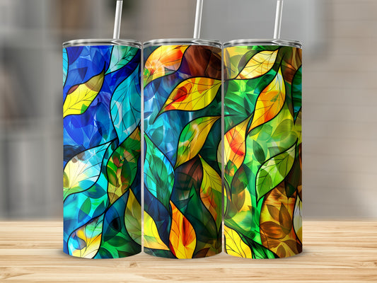 Three tumblers with stained-glass leaf patterns in blue, green, and gold.