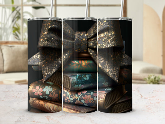 Three tumblers decorated with stacked books and a sparkly bow.