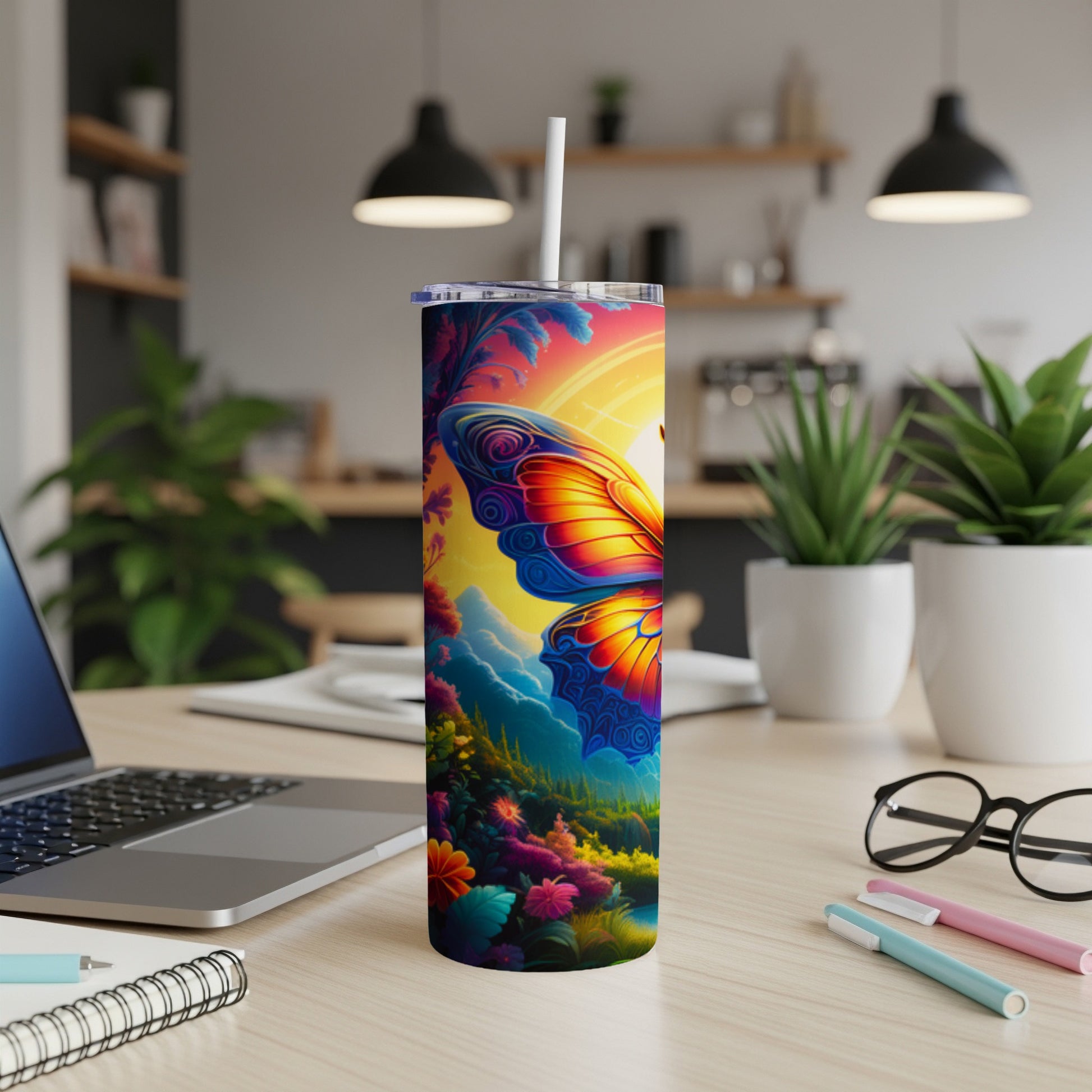 Tall tumbler with a vibrant butterfly and floral design on a desk.