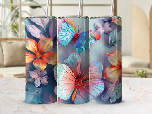 Three tumblers with colorful floral and butterfly designs on a light marble surface.