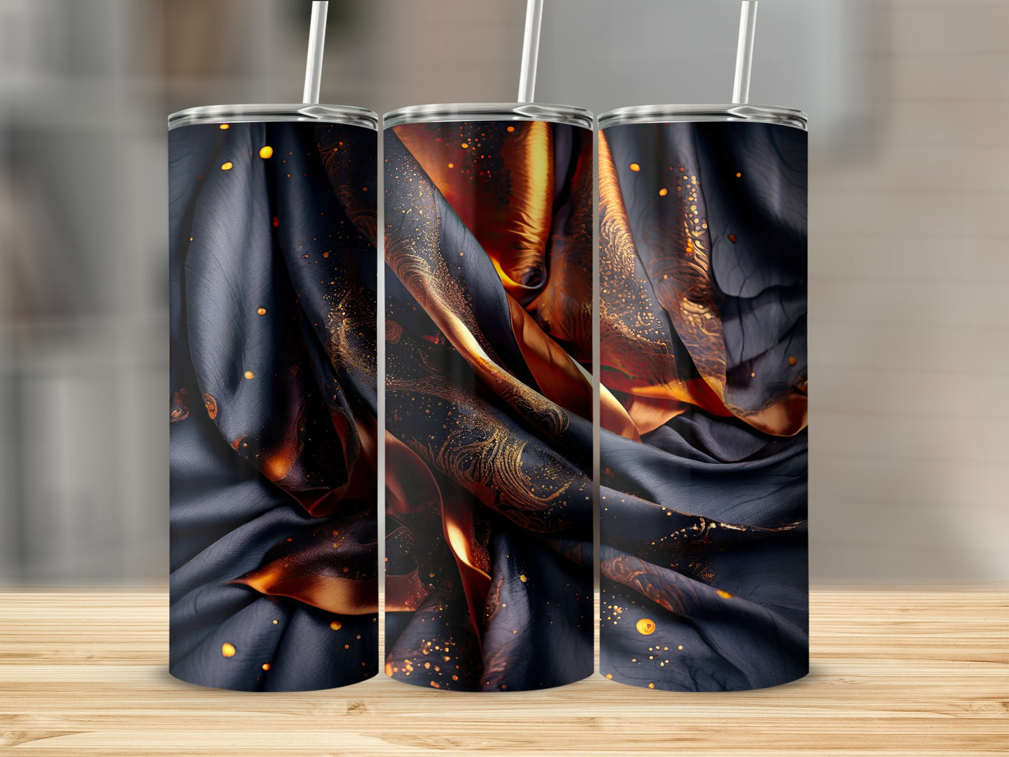 Dark fabric with gold swirls and speckles on three tumblers.