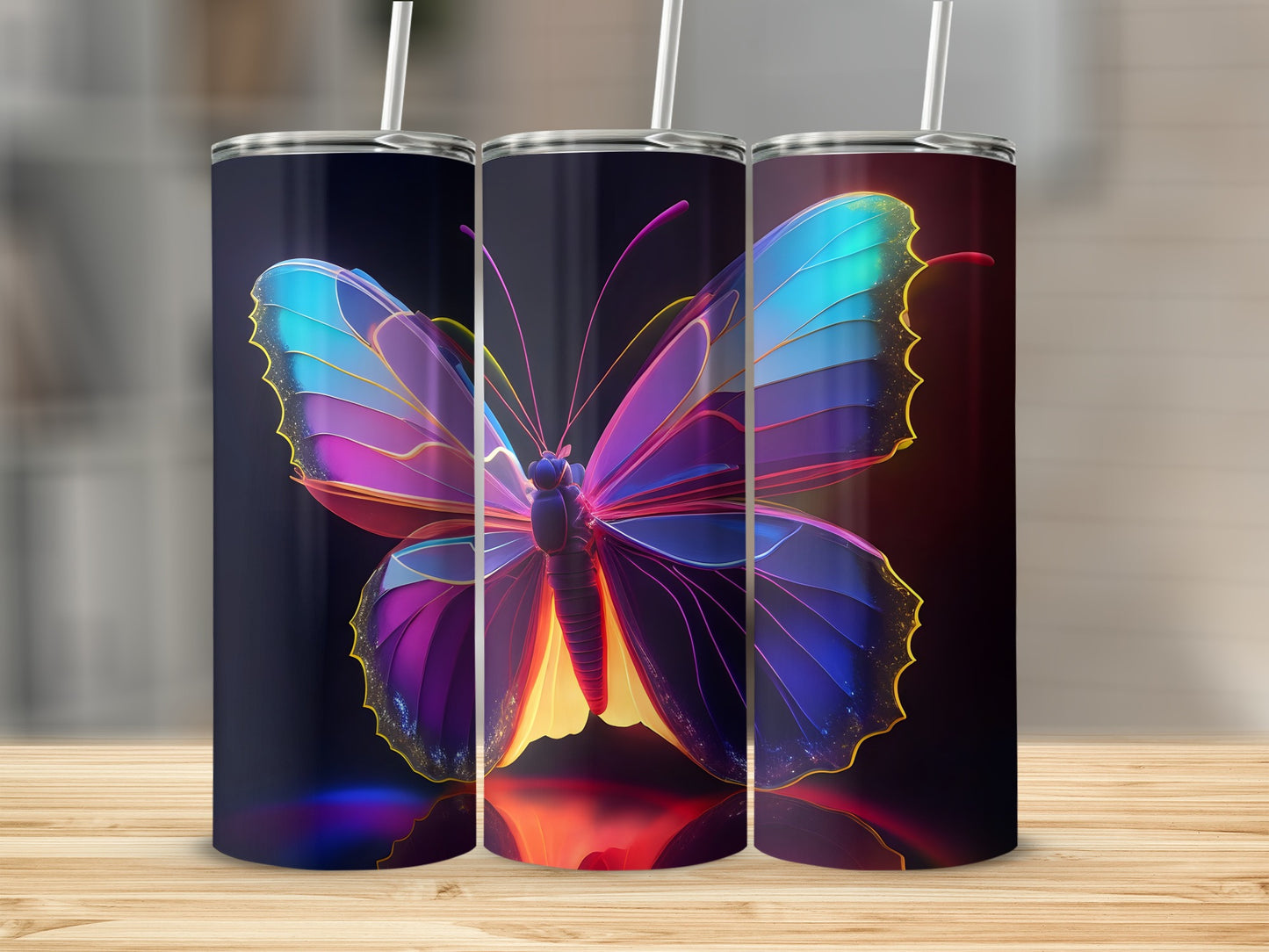 Three tumblers featuring a vibrant, glowing butterfly design.