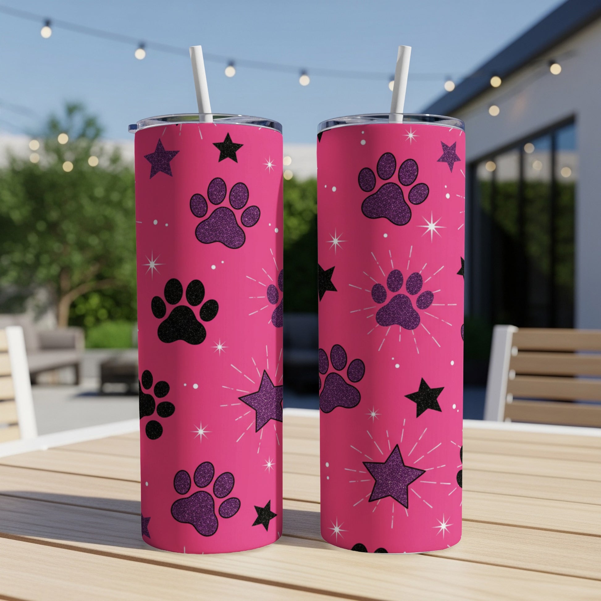Two pink tumblers with paw print and star glitter pattern.