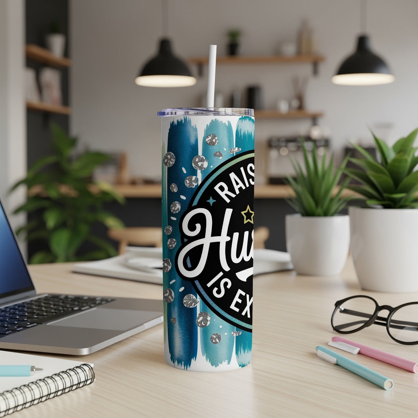 Tumbler with "Raising Humans is Ex" text and blue brush strokes and rhinestones.