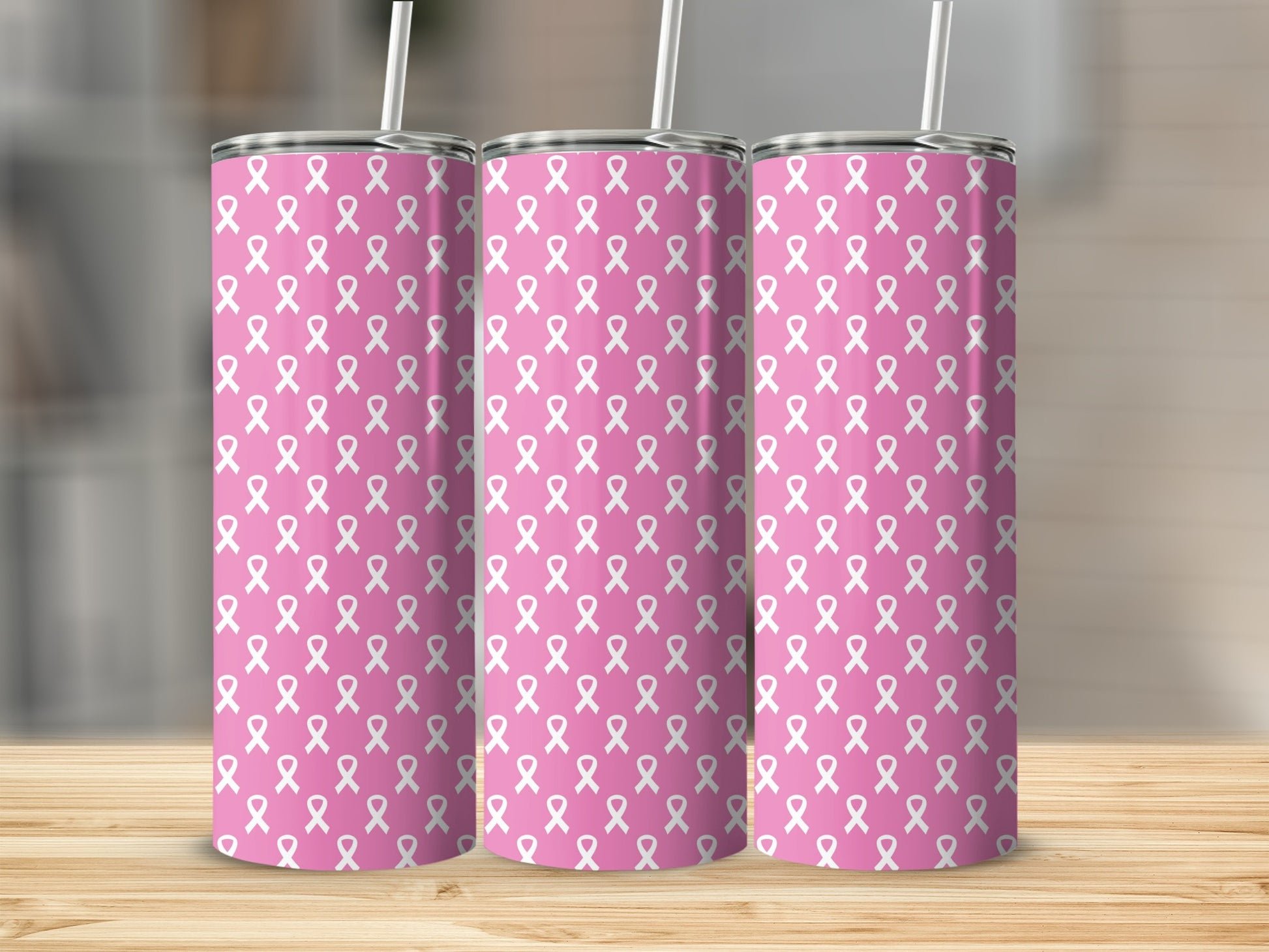 Three pink tumblers with a white ribbon pattern and straws.