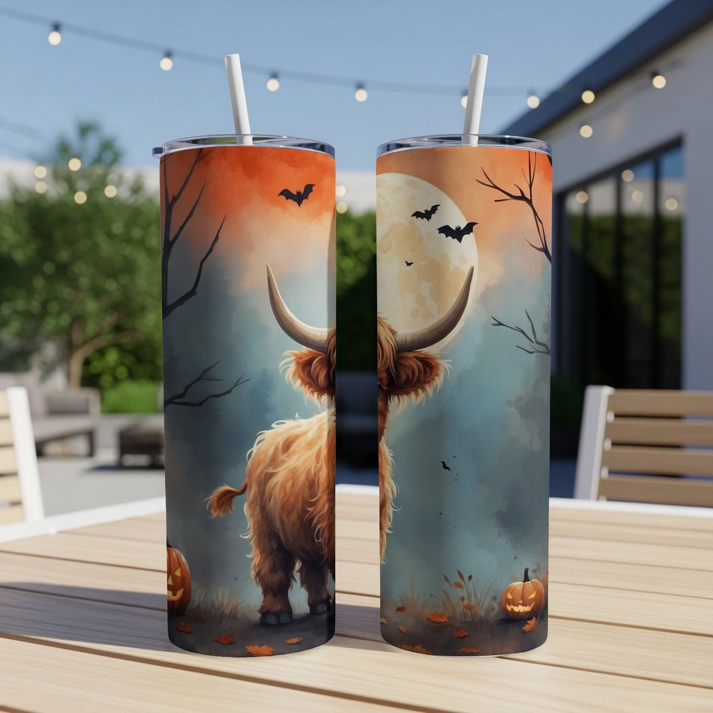 Two Highland cows with pumpkins and bats on Halloween tumblers.